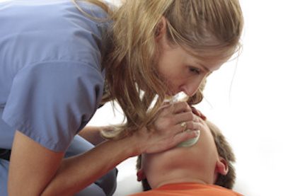 Nurse using a resuscitation mask on an child